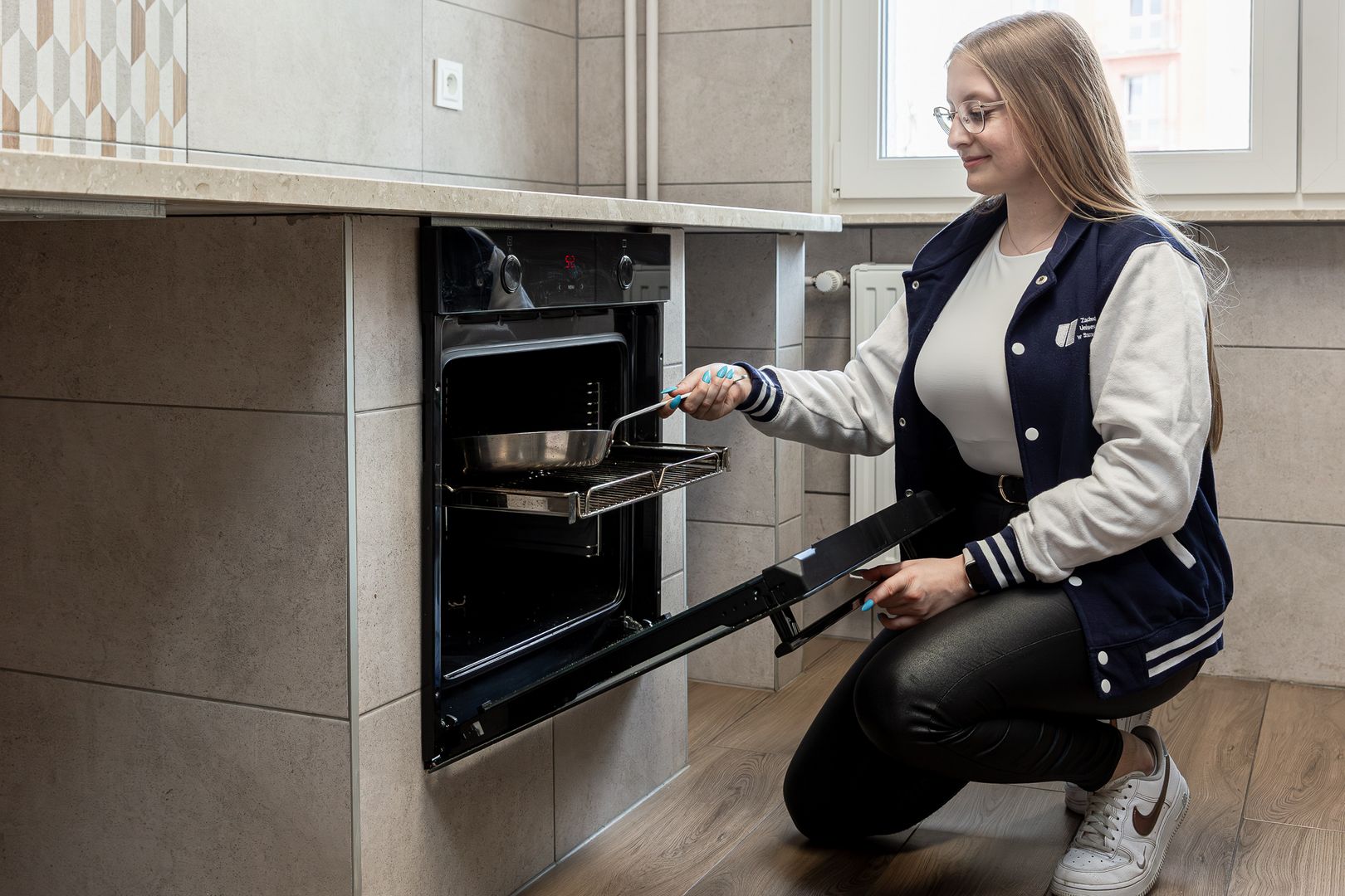 Widok na kuchnię w akademiku z blatem kuchennym i piekarnikiem